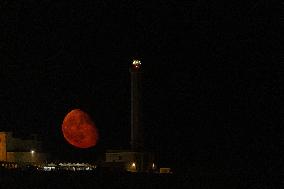 Waxing Gibbous Moon Rises Above The Lighthouse Of Santa Maria di Leuca