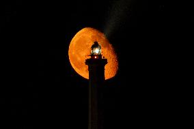 Waxing Gibbous Moon Rises Above The Lighthouse Of Santa Maria di Leuca