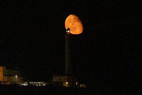 Waxing Gibbous Moon Rises Above The Lighthouse Of Santa Maria di Leuca