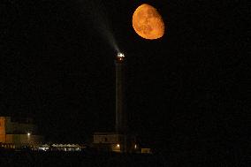 Waxing Gibbous Moon Rises Above The Lighthouse Of Santa Maria di Leuca