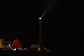 Waxing Gibbous Moon Rises Above The Lighthouse Of Santa Maria di Leuca