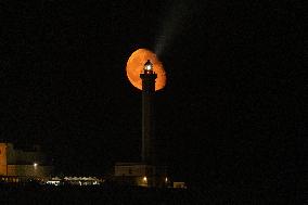 Waxing Gibbous Moon Rises Above The Lighthouse Of Santa Maria di Leuca