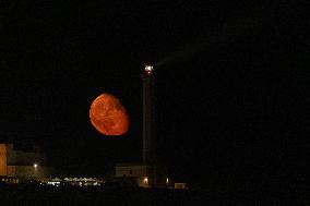 Waxing Gibbous Moon Rises Above The Lighthouse Of Santa Maria di Leuca