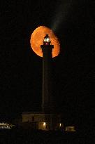 Waxing Gibbous Moon Rises Above The Lighthouse Of Santa Maria di Leuca