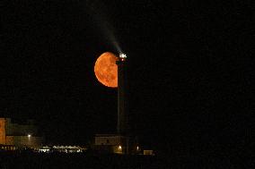 Waxing Gibbous Moon Rises Above The Lighthouse Of Santa Maria di Leuca