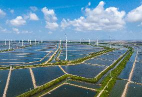 Wind Turbines Rotate in Vast Coastal Flat in Yancheng