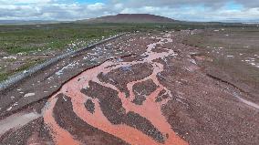 Red Rivers Flow Through Grassland in Haixi