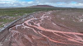 Red Rivers Flow Through Grassland in Haixi