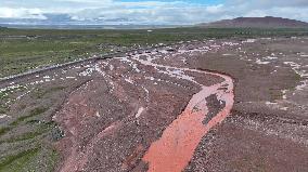 Red Rivers Flow Through Grassland in Haixi