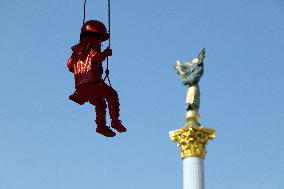 Sculpture of girl on swing by James Colomina in Kyiv