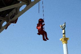 Sculpture of girl on swing by James Colomina in Kyiv