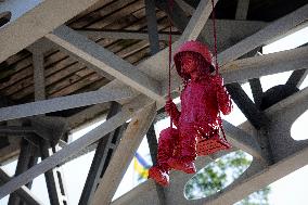 Sculpture of girl on swing by James Colomina in Kyiv