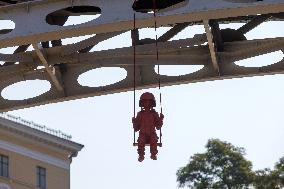 Sculpture of girl on swing by James Colomina in Kyiv