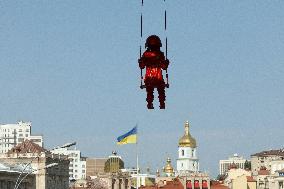 Sculpture of girl on swing by James Colomina in Kyiv