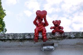 Sculpture of child with heart and teddy bear by James Colomina in Kyiv