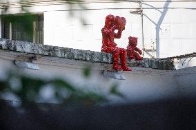 Sculpture of child with heart and teddy bear by James Colomina in Kyiv