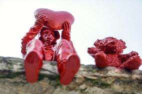 Sculpture of child with heart and teddy bear by James Colomina in Kyiv