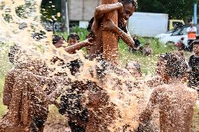 Greasy muddy pole climbing game in South Tangerang