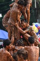 Greasy muddy pole climbing game in South Tangerang