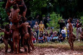 Greasy muddy pole climbing game in South Tangerang