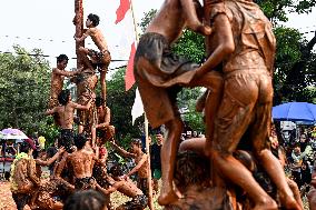 Greasy muddy pole climbing game in South Tangerang