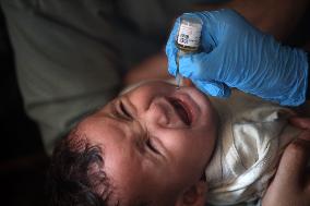 Palestinian Child Receives Polio Vaccine at UN Center in Gaza Amid Conflict