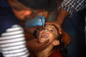 Palestinian Child Receives Polio Vaccine at UN Center in Gaza Amid Conflict