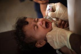 Palestinian Child Receives Polio Vaccine at UN Center in Gaza Amid Conflict