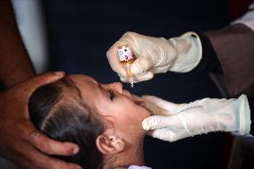 Palestinian Child Receives Polio Vaccine at UN Center in Gaza Amid Conflict