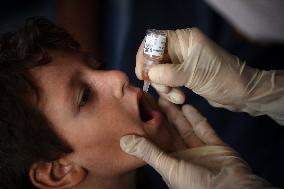 Palestinian Child Receives Polio Vaccine at UN Center in Gaza Amid Conflict