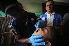 Palestinian Child Receives Polio Vaccine at UN Center in Gaza Amid Conflict