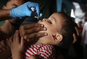 Palestinian Child Receives Polio Vaccine at UN Center in Gaza Amid Conflict