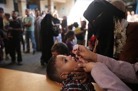 Palestinian Child Receives Polio Vaccine at UN Center in Gaza Amid Conflict