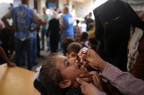 Palestinian Child Receives Polio Vaccine at UN Center in Gaza Amid Conflict