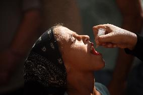 Palestinian Child Receives Polio Vaccine at UN Center in Gaza Amid Conflict