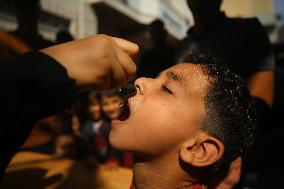 Palestinian Child Receives Polio Vaccine at UN Center in Gaza Amid Conflict