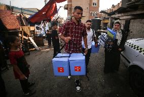 Palestinian Child Receives Polio Vaccine at UN Center in Gaza Amid Conflict