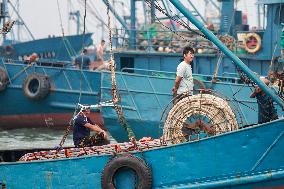 Fishing boats departing from a port for fishing in Rongcheng City