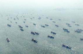 Fishing boats departing from a port for fishing in Rongcheng City