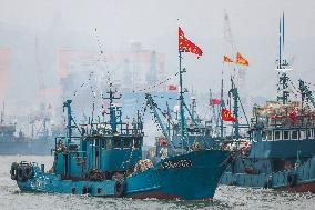 Fishing boats departing from a port for fishing in Rongcheng City