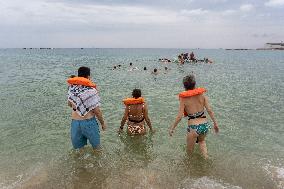 The "Swim With Gaza" Initiative On The Beach Of Barcelona.