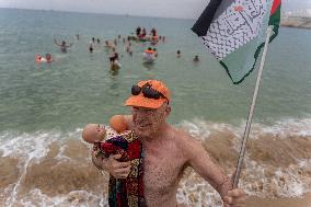 The "Swim With Gaza" Initiative On The Beach Of Barcelona.