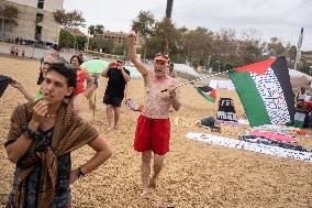 The "Swim With Gaza" Initiative On The Beach Of Barcelona.