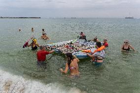 The "Swim With Gaza" Initiative On The Beach Of Barcelona.