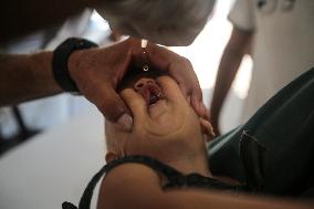 Palestinian Child Receives Polio Vaccine at UK-MED Hospital in Gaza Amid Ongoing Conflict