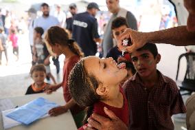 Palestinian Child Receives Polio Vaccine at UK-MED Hospital in Gaza Amid Ongoing Conflict