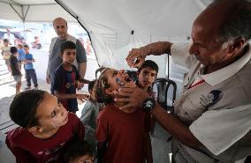 Palestinian Child Receives Polio Vaccine at UK-MED Hospital in Gaza Amid Ongoing Conflict