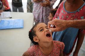 Palestinian Child Receives Polio Vaccine at UK-MED Hospital in Gaza Amid Ongoing Conflict