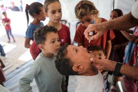 Palestinian Child Receives Polio Vaccine at UK-MED Hospital in Gaza Amid Ongoing Conflict