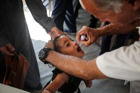 Palestinian Child Receives Polio Vaccine at UK-MED Hospital in Gaza Amid Ongoing Conflict